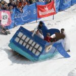 Cardboard Classic participants fly down the hill in their shark vehicle